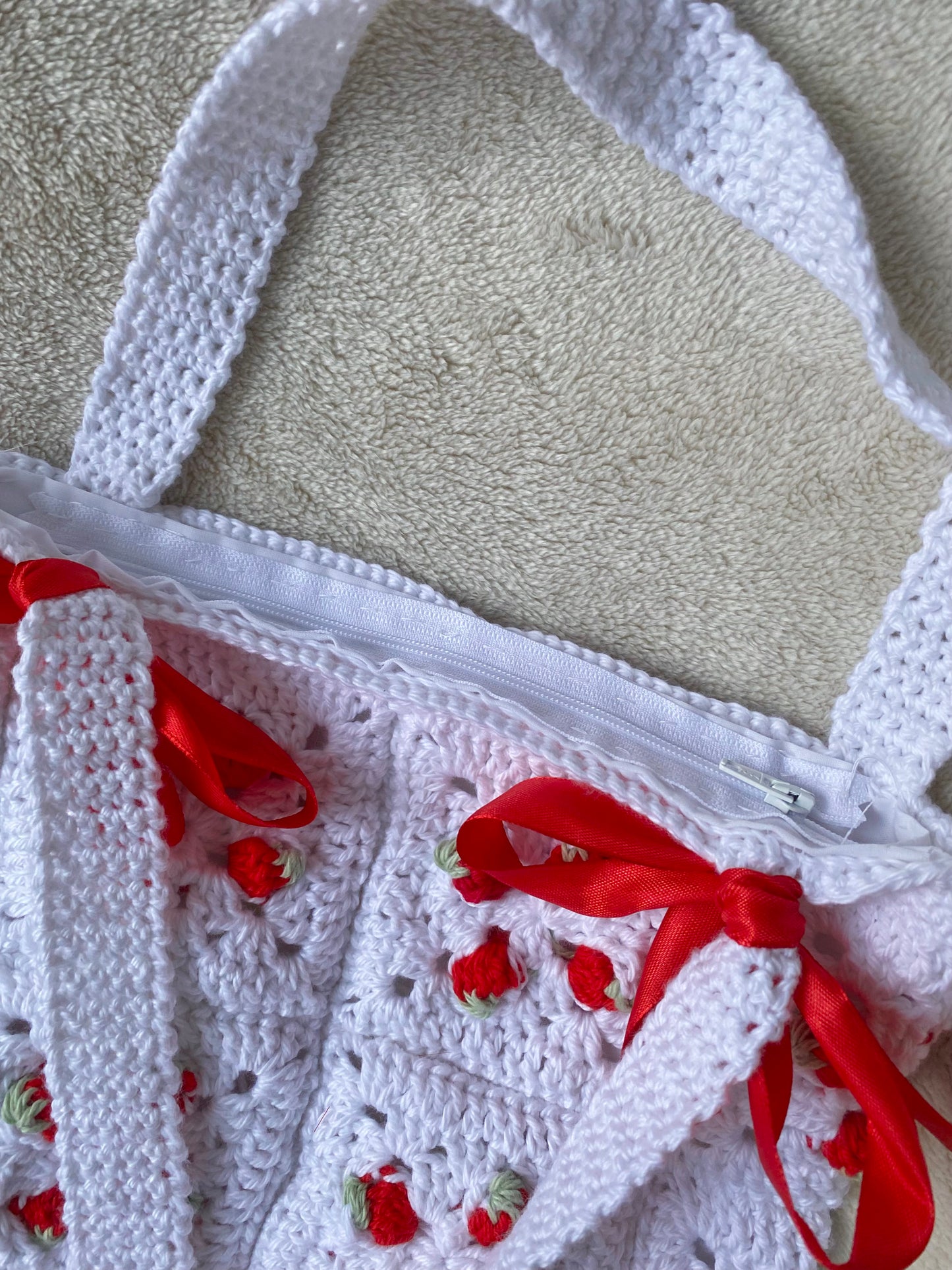 Cute crochet bag with strawberries and ribbons