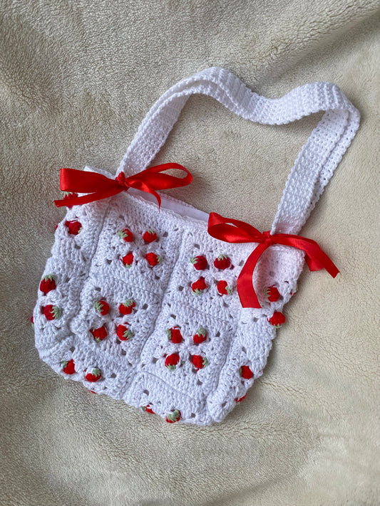 Cute crochet bag with strawberries and ribbons