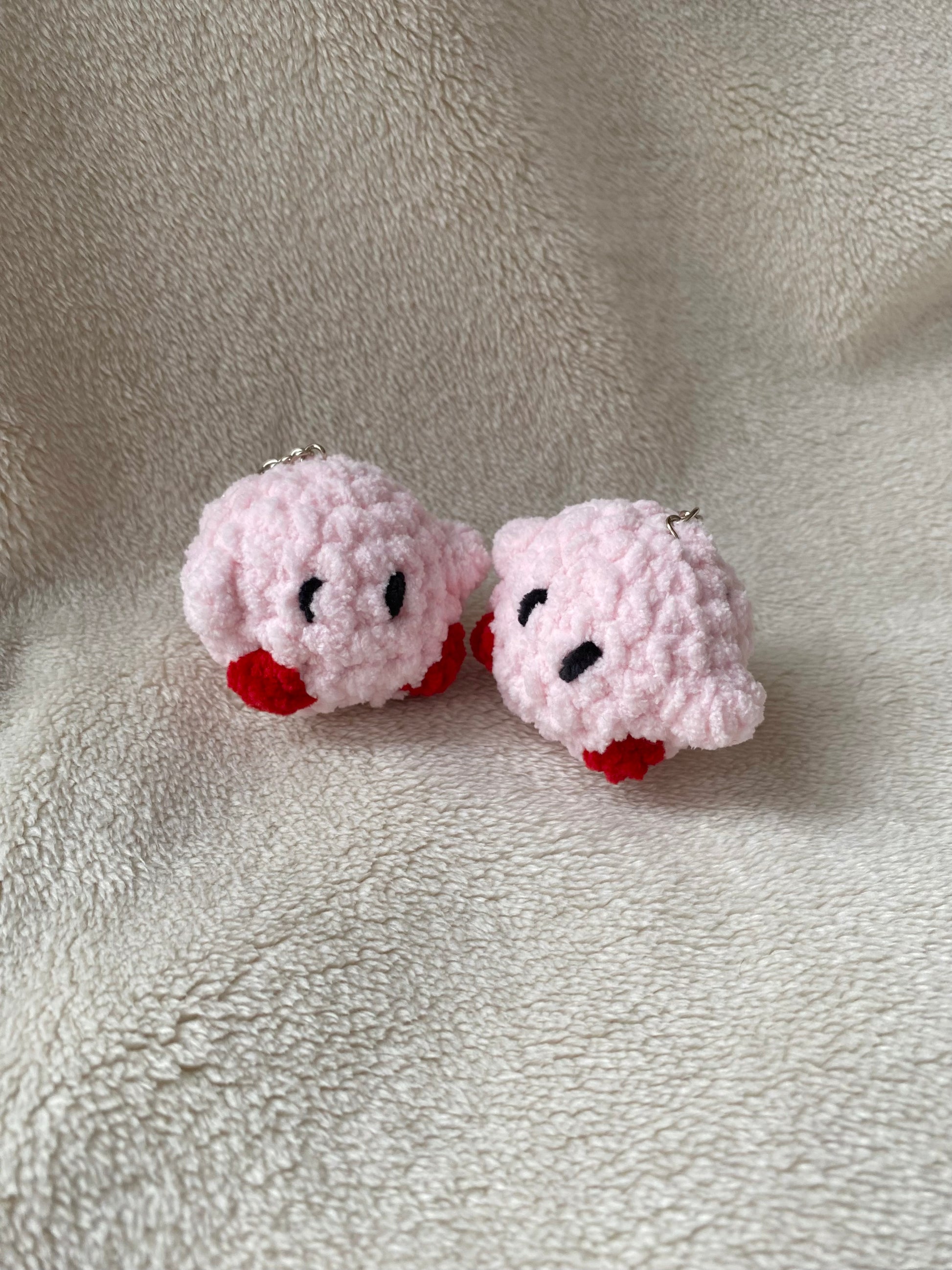 Cute crochet Kirby keyring made with plush and fluffy yarn